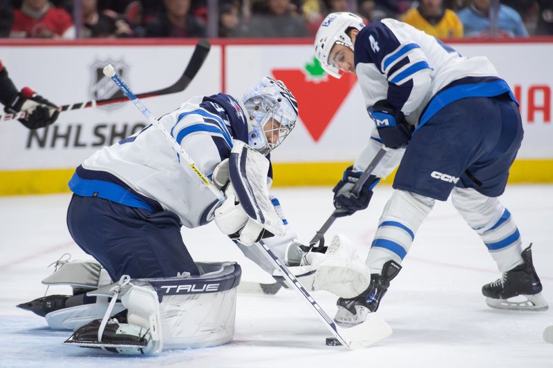 Jan 20, 2024; Ottawa, Ontario, CAN; Winnipeg Jets goalie Connor Hellebuyck (37) makes a save in the first period against the Ottawa Senators at the Canadian Tire Centre. Mandatory Credit: Marc DesRosiers-USA TODAY Sports