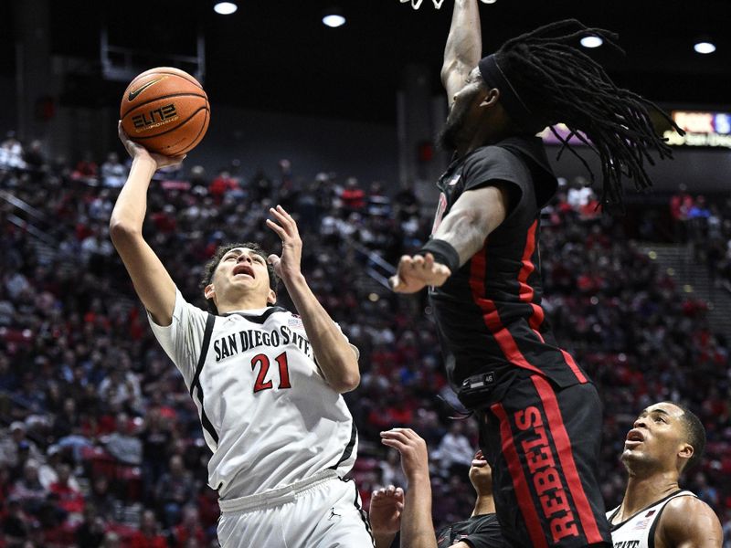 Jan 6, 2024; San Diego, California, USA; San Diego State Aztecs guard Miles Byrd (21) shoots the ball over UNLV Rebels forward Keylan Boone (20) during the first half at Viejas Arena. Mandatory Credit: Orlando Ramirez-USA TODAY Sports