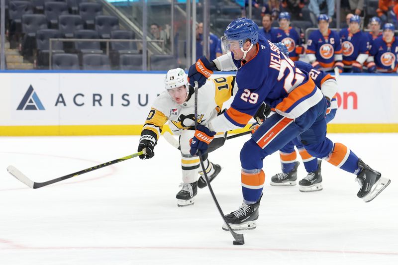 Nov 5, 2024; Elmont, New York, USA; New York Islanders center Brock Nelson (29) takes a shot against Pittsburgh Penguins left wing Drew O'Connor (10) during overtime at UBS Arena. Mandatory Credit: Brad Penner-Imagn Images