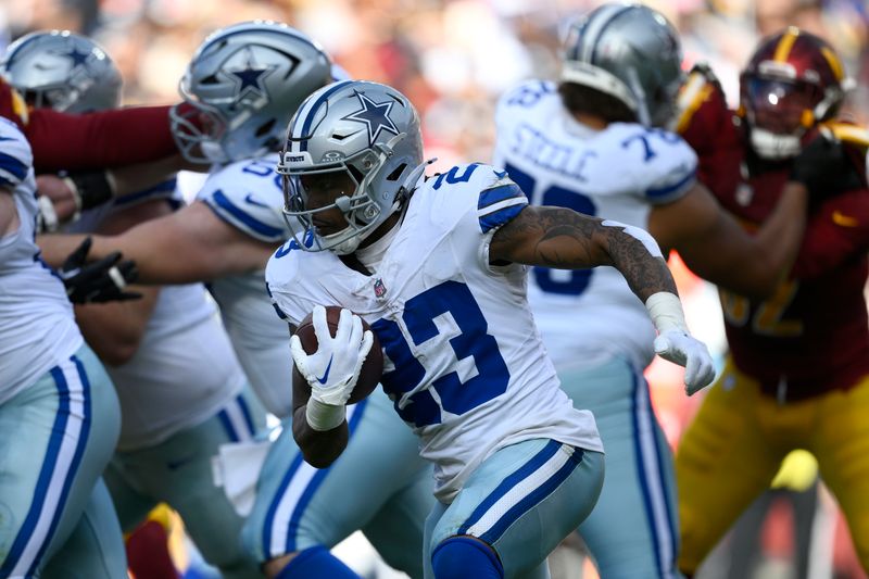 Dallas Cowboys running back Rico Dowdle (23) runs with the football during the first half of an NFL football game against the Washington Commanders, Sunday, Nov. 24, 2024, in Landover, Md. (AP Photo/Nick Wass)