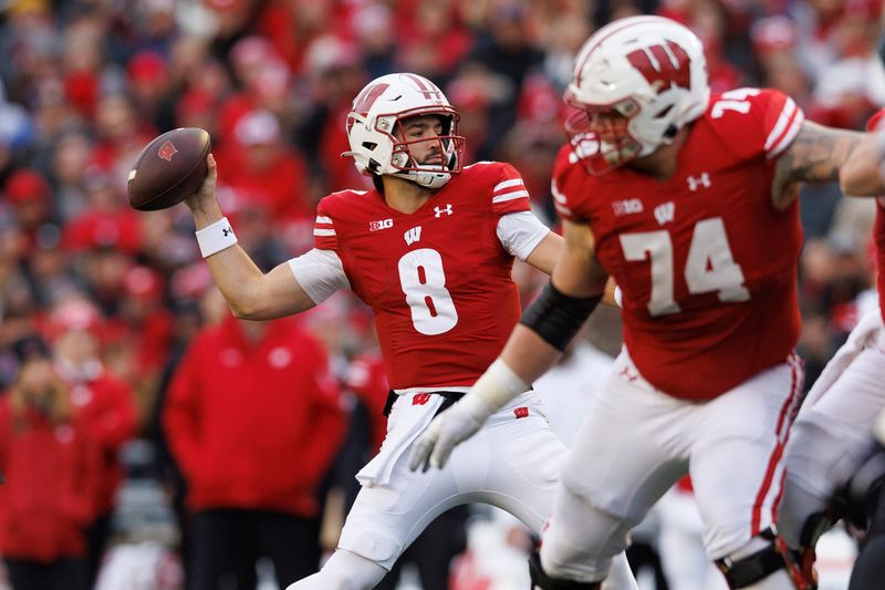 Nov 11, 2023; Madison, Wisconsin, USA;  Wisconsin Badgers quarterback Tanner Mordecai (8) throws a pass during the second quarter against the Northwestern Wildcats at Camp Randall Stadium. Mandatory Credit: Jeff Hanisch-USA TODAY Sports