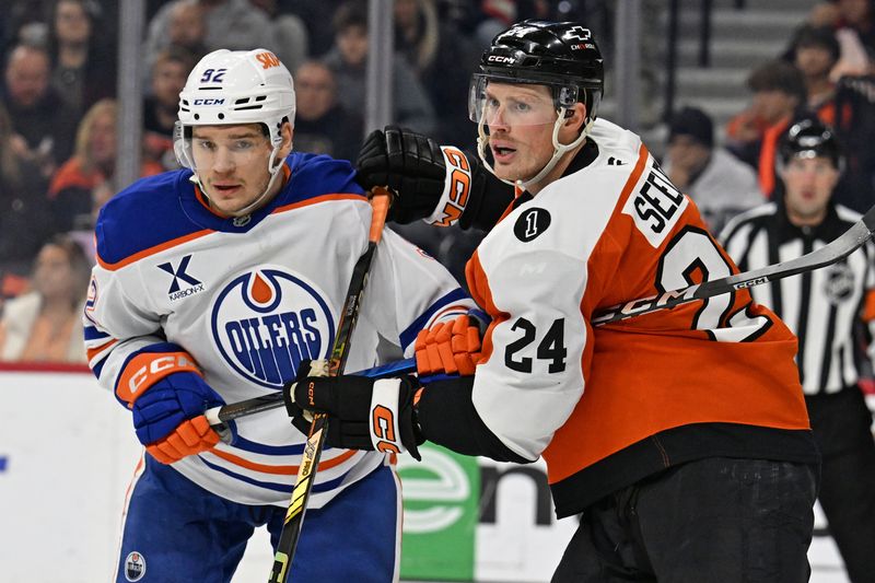 Nov 12, 2025; Philadelphia, Pennsylvania, USA; Edmonton Oilers right wing Vasily Podkolzin (92) and Philadelphia Flyers defenseman Nick Seeler (24) battle for position during the second period at Xfinity Mobile Arena. Mandatory Credit: Eric Hartline-Imagn Images