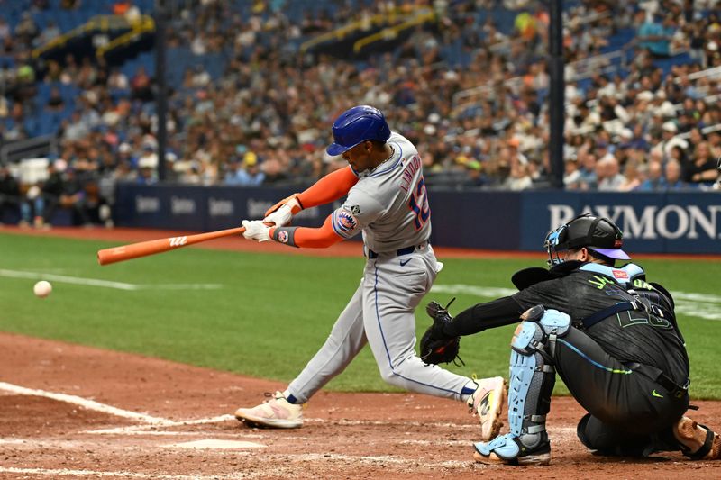 May 5, 2024; St. Petersburg, Florida, USA; New York Mets short stop Francisco Lindor (12) singles in the fourth inning against the Tampa Bay Rays  at Tropicana Field. Mandatory Credit: Jonathan Dyer-USA TODAY Sports