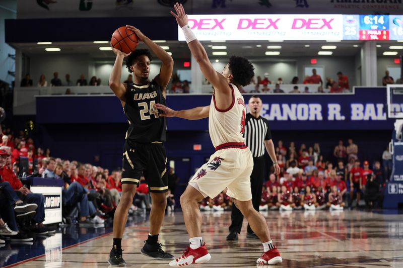 Jan 14, 2024; Boca Raton, Florida, USA; UAB Blazers guard Efrem Johnson (24) protects the basketball from Florida Atlantic Owls guard Bryan Greenlee (4) during the first half at Eleanor R. Baldwin Arena. Mandatory Credit: Sam Navarro-USA TODAY Sports