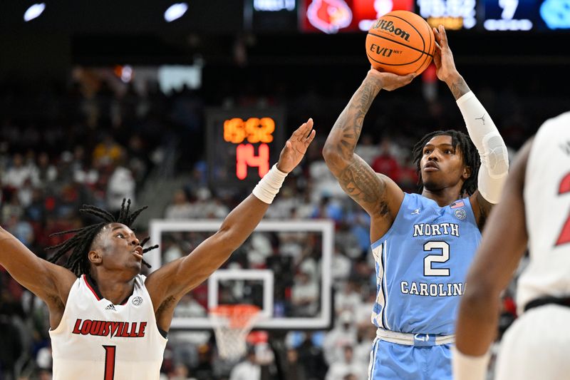 Jan 14, 2023; Louisville, Kentucky, USA;  North Carolina Tar Heels guard Caleb Love (2) shoots against Louisville Cardinals guard Mike James (1) during the first half at KFC Yum! Center. North Carolina defeated Louisville 80-59. Mandatory Credit: Jamie Rhodes-USA TODAY Sports