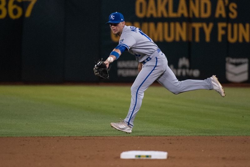 Aug 22, 2023; Oakland, California, USA; Kansas City Royals second baseman Michael Massey (19) flips the ball to shortstop Bobby Witt Jr. (7, not pictured) during the seventh inning against the Oakland Athletics at Oakland-Alameda County Coliseum. Mandatory Credit: Ed Szczepanski-USA TODAY Sports