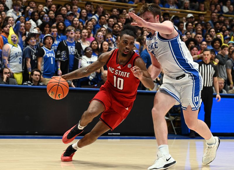 Jan 27, 2025; Durham, North Carolina, USA; North Carolina State Wolfpack guard Marcus Hill (10) drives to the basket as North Carolina State Wolfpack guard Marcus Hill (10) defends during the first half at Cameron Indoor Stadium. Mandatory Credit: Rob Kinnan-Imagn Images