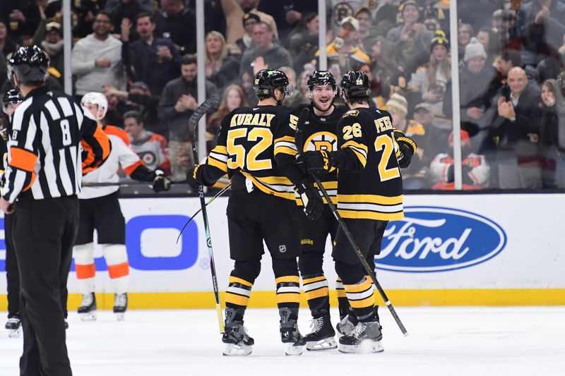 Jan 29, 2026; Boston, Massachusetts, USA; Boston Bruins left wing Tanner Jeannot (84) is congratulated by center Sean Kuraly (52) and defenseman Andrew Peeke (26) after scoring a goal during the second period against the Philadelphia Flyers at TD Garden. Mandatory Credit: Bob DeChiara-Imagn Images