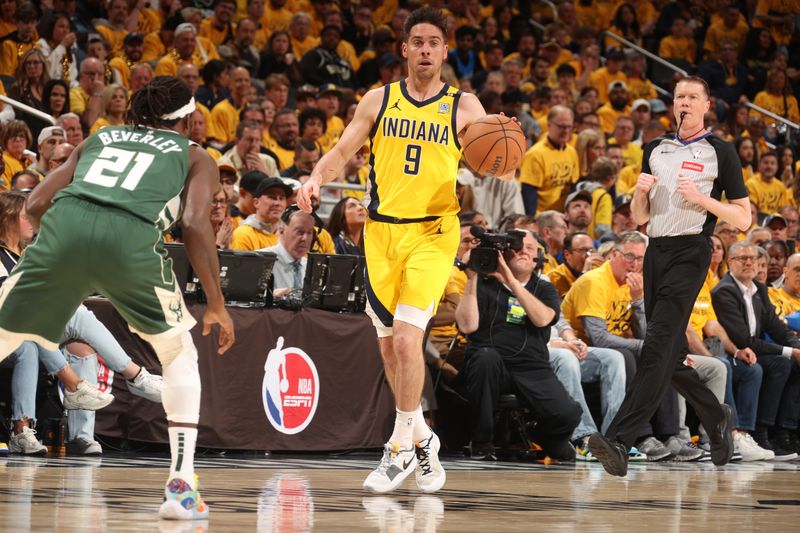 INDIANAPOLIS, IN - APRIL 26: T.J. McConnell #9 of the Indiana Pacers dribbles the ball during the game against the Milwaukee Bucks during Round 1 Game 3 of the 2024 NBA Playoffs on April 26, 2024 at Gainbridge Fieldhouse in Indianapolis, Indiana. NOTE TO USER: User expressly acknowledges and agrees that, by downloading and or using this Photograph, user is consenting to the terms and conditions of the Getty Images License Agreement. Mandatory Copyright Notice: Copyright 2023 NBAE (Photo by Nathaniel S. Butler/NBAE via Getty Images)