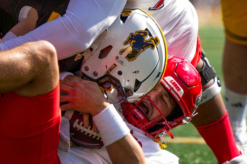 Sep 30, 2023; Laramie, Wyoming, USA; New Mexico Lobos quarterback Dylan Hopkins (bottom) is sacked by Wyoming Cowboys safety Wyett Ekeler (top) during the first quarter at Jonah Field at War Memorial Stadium. Mandatory Credit: Troy Babbitt-USA TODAY Sports

