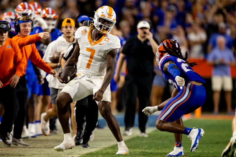 Sep 16, 2023; Gainesville, Florida, USA; Tennessee Volunteers quarterback Joe Milton III (7) smiles at Florida Gators cornerback Jaydon Hill (23) while stepping out of bounds during the second half at Ben Hill Griffin Stadium. Mandatory Credit: Matt Pendleton-USA TODAY Sports