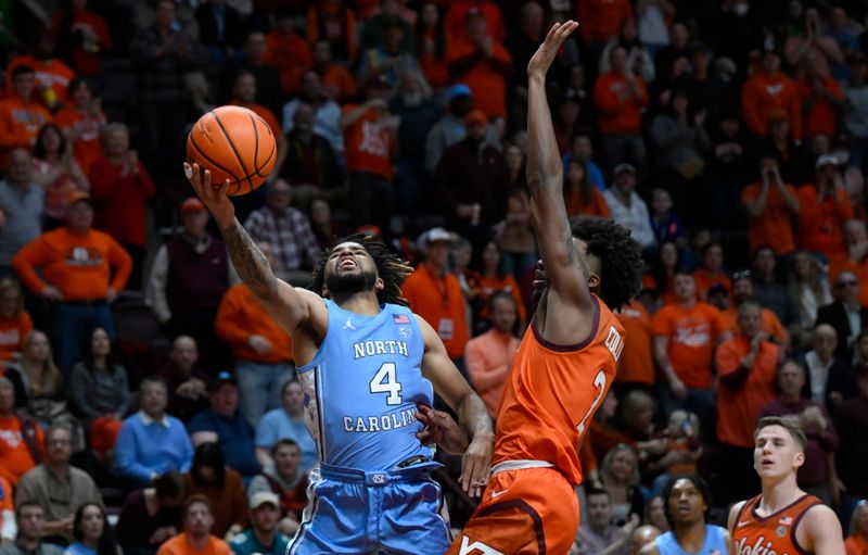 Dec 4, 2022; Blacksburg, Virginia, USA; North Carolina Tar Heels guard R.J. Davis (4) drives to basket as Virginia Tech Hokies guard Michael Collins Jr. (2) defends in the first half. at Cassell Coliseum. Mandatory Credit: Lee Luther Jr.-USA TODAY Sports