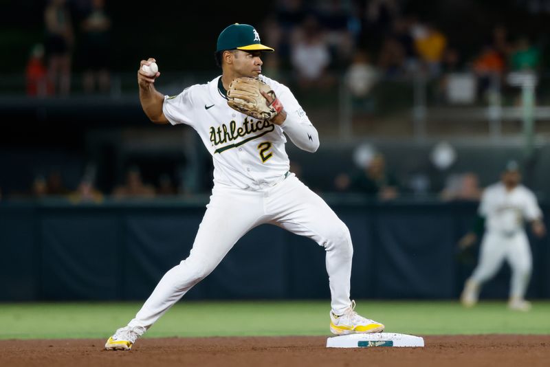 Sep 23, 2025; West Sacramento, California, USA; Athletics second baseman Darell Hernaiz (2) throws to first for a double play during the eighth inning against the Houston Astros at Sutter Health Park. Mandatory Credit: Sergio Estrada-Imagn Images