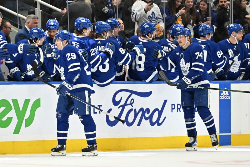 Mar 23, 2024; Toronto, Ontario, CAN; Toronto Maple Leafs forward Pontus Holmberg (29) leads forward Bobby McMann (74) as he celebrates with team mates after scoring against the Edmonton Oilers in the second period at Scotiabank Arena. Mandatory Credit: Dan Hamilton-USA TODAY Sports