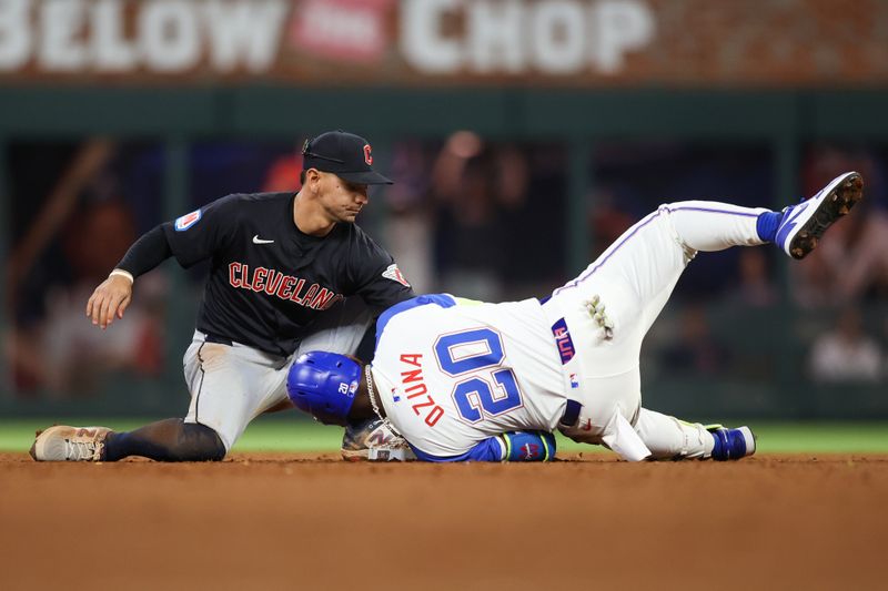 Apr 27, 2024; Atlanta, Georgia, USA; Atlanta Braves designated hitter Marcell Ozuna (20) slides past Cleveland Guardians second baseman Andres Gimenez (0) for a double in the eighth inning at Truist Park. Mandatory Credit: Brett Davis-USA TODAY Sports
