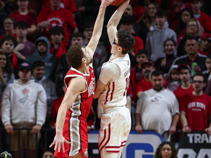 Mar 10, 2024; Piscataway, New Jersey, USA; Ohio State Buckeyes forward Jamison Battle (10) blocks a shot by Rutgers Scarlet Knights guard Gavin Griffiths (10) during the first half at Jersey Mike's Arena. Mandatory Credit: Vincent Carchietta-USA TODAY Sports