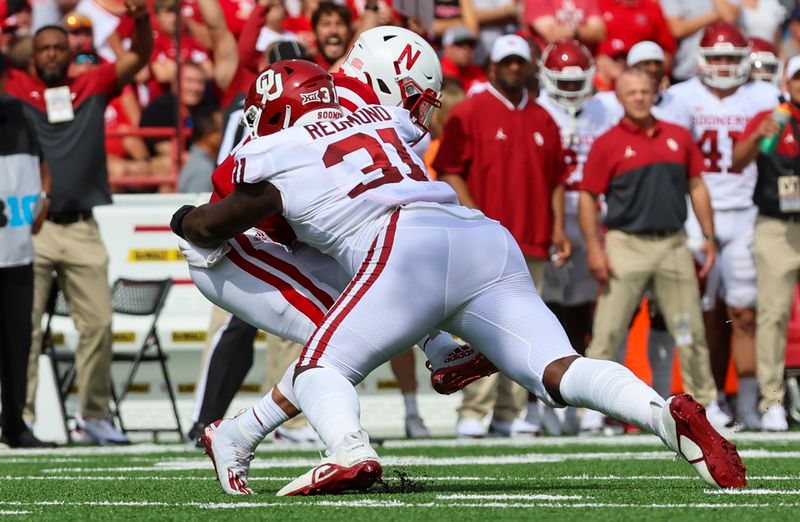 Sep 17, 2022; Lincoln, Nebraska, USA;  Oklahoma Sooners defensive lineman Jalen Redmond (31) sacks Nebraska Cornhuskers quarterback Casey Thompson (11) during the first half at Memorial Stadium. Mandatory Credit: Kevin Jairaj-USA TODAY Sports