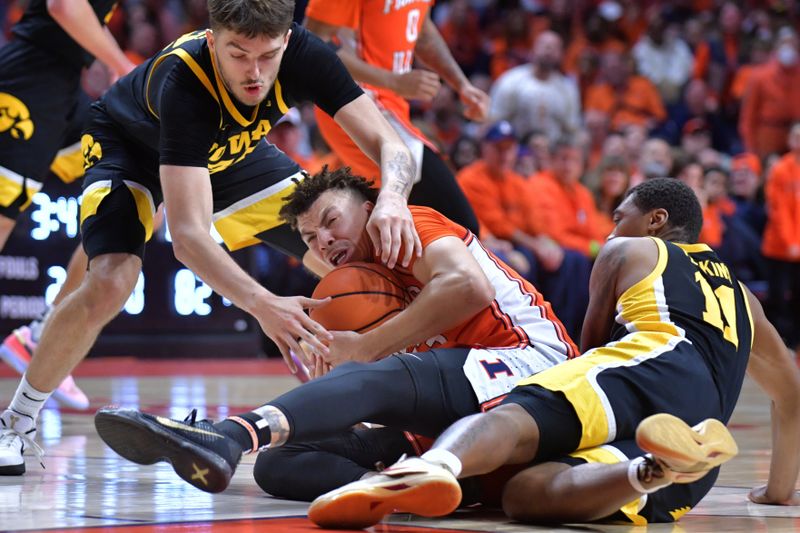 Feb 24, 2024; Champaign, Illinois, USA;  Illinois Fighting Illini forward Coleman Hawkins (33) grabs a loose ball between Iowa Hawkeyes forward Owen Freeman (32) and guard Tony Perkins (11) during the second half at State Farm Center. Mandatory Credit: Ron Johnson-USA TODAY Sports