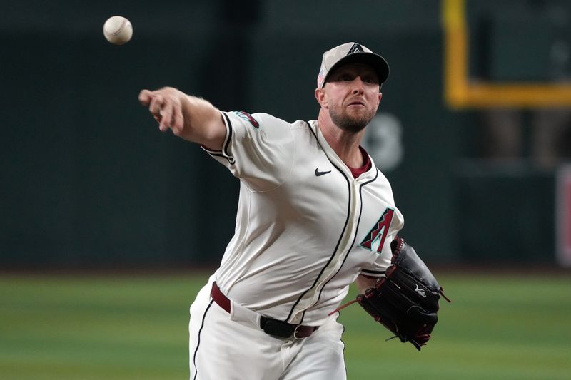May 18, 2025; Phoenix, Arizona, USA; Arizona Diamondbacks pitcher Merrill Kelly (29) throws against the Colorado Rockies in the first inning at Chase Field. Mandatory Credit: Rick Scuteri-Imagn Images
