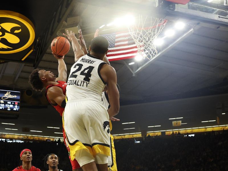 Jan 15, 2023; Iowa City, Iowa, USA; Maryland Terrapins forward Pavlo Dziuba (12) is blocked by Iowa Hawkeyes forward Kris Murray (24) at Carver-Hawkeye Arena. Mandatory Credit: Reese Strickland-USA TODAY Sports