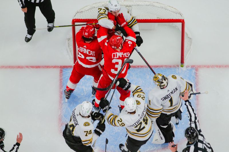 Dec 31, 2023; Detroit, Michigan, USA; Detroit Red Wings left wing J.T. Compher (37) and right wing Alex DeBrincat (93) scuffle with Boston Bruins defenseman Charlie McAvoy (73) in front of the net during the game between the Boston Bruins and the Detroit Red Wings at Little Caesars Arena. Mandatory Credit: Brian Bradshaw Sevald-USA TODAY Sports