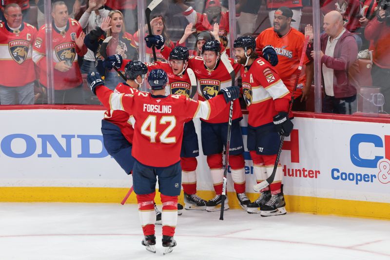 Oct 7, 2025; Sunrise, Florida, USA;  Florida Panthers center Jesper Boqvist (70) celebrates with teammates after scoring against the Chicago Blackhawks during the third period at Amerant Bank Arena. Mandatory Credit: Sam Navarro-Imagn Images