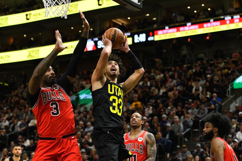SALT LAKE CITY, UTAH - MARCH 06: Johnny Juzang #33 of the Utah Jazz shoots over Andre Drummond #3 of the Chicago Bulls during the second half of a game at Delta Center on March 06, 2024 in Salt Lake City, Utah. NOTE TO USER: User expressly acknowledges and agrees that, by downloading and or using this photograph, User is consenting to the terms and conditions of the Getty Images License Agreement.  (Photo by Alex Goodlett/Getty Images)