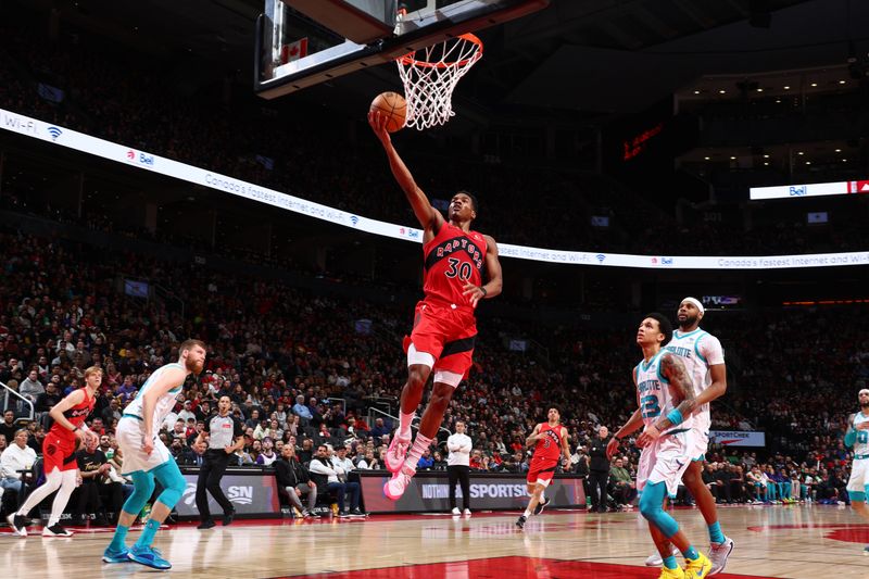 TORONTO, CANADA - MARCH 3: Ochai Agbaji #30 of the Toronto Raptors drives to the basket during the game against the Charlotte Hornets on March 3, 2024 at the Scotiabank Arena in Toronto, Ontario, Canada.  NOTE TO USER: User expressly acknowledges and agrees that, by downloading and or using this Photograph, user is consenting to the terms and conditions of the Getty Images License Agreement.  Mandatory Copyright Notice: Copyright 2024 NBAE (Photo by Vaughn Ridley/NBAE via Getty Images)