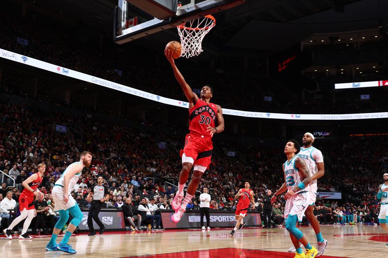 TORONTO, CANADA - MARCH 3: Ochai Agbaji #30 of the Toronto Raptors drives to the basket during the game against the Charlotte Hornets on March 3, 2024 at the Scotiabank Arena in Toronto, Ontario, Canada.  NOTE TO USER: User expressly acknowledges and agrees that, by downloading and or using this Photograph, user is consenting to the terms and conditions of the Getty Images License Agreement.  Mandatory Copyright Notice: Copyright 2024 NBAE (Photo by Vaughn Ridley/NBAE via Getty Images)