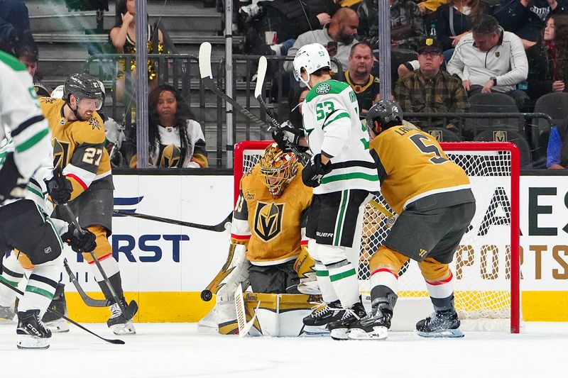 Jan 29, 2026; Las Vegas, Nevada, USA; Vegas Golden Knights goaltender Adin Hill (33) makes a save as Dallas Stars center Wyatt Johnston (53) looks for the rebound during the second period at T-Mobile Arena. Mandatory Credit: Stephen R. Sylvanie-Imagn Images