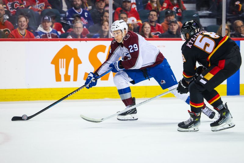 Mar 12, 2024; Calgary, Alberta, CAN; Colorado Avalanche center Nathan MacKinnon (29) controls the puck against Calgary Flames defenseman Oliver Kylington (58) during the first period at Scotiabank Saddledome. Mandatory Credit: Sergei Belski-USA TODAY Sports