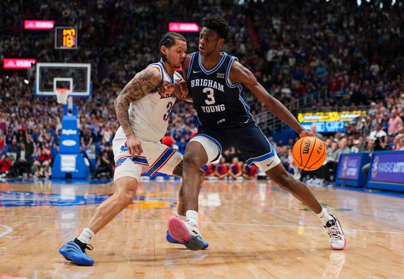 Jan 31, 2026; Lawrence, Kansas, USA; BYU Cougars forward AJ Dybantsa (3) drives against Kansas Jayhawks guard Tre White (3) during the first half at Allen Fieldhouse. Mandatory Credit: Jay Biggerstaff-Imagn Images