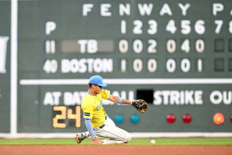 Sep 28, 2024; Boston, Massachusetts, USA; Boston Red Sox second baseman Vaughn Grissom (5) chases a loose ball during the seventh inning of a game against the Tampa Bay Rays at Fenway Park. Mandatory Credit: Brian Fluharty-Imagn Images