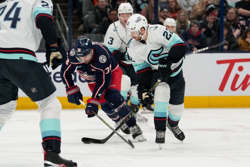 Mar 3, 2023; Columbus, Ohio, USA;  Columbus Blue Jackets center Boone Jenner (38) and Seattle Kraken right wing Oliver Bjorkstrand (22) battle for the puck during the second period at Nationwide Arena. Mandatory Credit: Jason Mowry-USA TODAY Sports