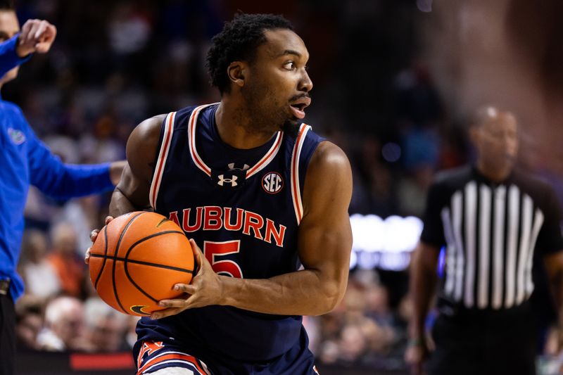 Feb 10, 2024; Gainesville, Florida, USA; Auburn Tigers forward Chris Moore (5) looks to pass against the Florida Gators during the first half at Exactech Arena at the Stephen C. O'Connell Center. Mandatory Credit: Matt Pendleton-USA TODAY Sports