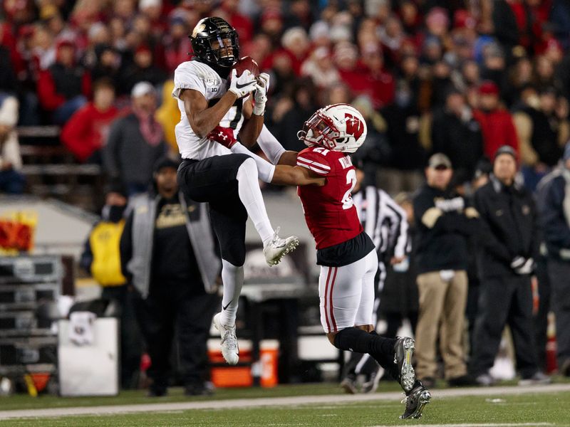 Nov 23, 2019; Madison, WI, USA; Purdue Boilermakers wide receiver Milton Wright (17) catches a pass in front of Wisconsin Badgers cornerback Caesar Williams (21) during the third quarter at Camp Randall Stadium. Mandatory Credit: Jeff Hanisch-USA TODAY Sports