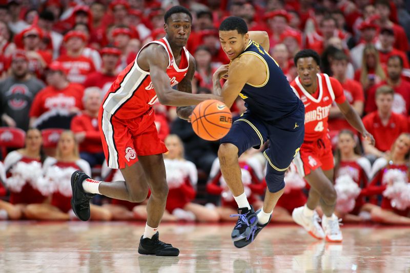 Mar 3, 2024; Columbus, Ohio, USA;  Ohio State Buckeyes guard Scotty Middleton (0) and Michigan Wolverines guard Nimari Burnett (4) go after the loose ball during the second half at Value City Arena. Mandatory Credit: Joseph Maiorana-USA TODAY Sports