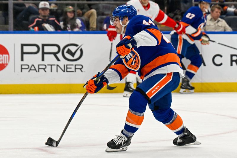 Oct 23, 2025; Elmont, New York, USA;  New York Islanders center Jean-Gabriel Pageau (44) attempts a shot against the Detroit Red Wings during the second period at UBS Arena. Mandatory Credit: Dennis Schneidler-Imagn Images