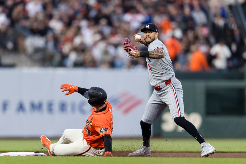 Jul 12, 2024; San Francisco, California, USA; Minnesota Twins shortstop Carlos Correa (4) throws to first base after tagging San Francisco Giants third baseman Matt Chapman (26) for a double play during the fourth inning at Oracle Park. Mandatory Credit: John Hefti-USA TODAY Sports