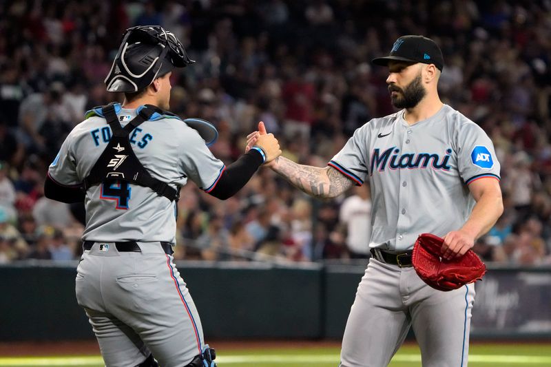 May 26, 2024; Phoenix, Arizona, USA; Miami Marlins catcher Nick Fortes (4) and pitcher Tanner Scott (66) celebrate after defeating the Arizona Diamondbacks at Chase Field. Mandatory Credit: Rick Scuteri-USA TODAY Sports