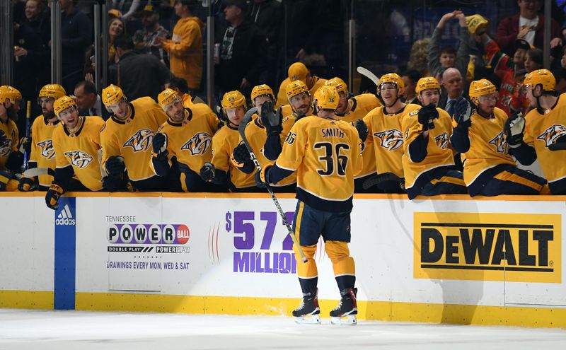 Jan 26, 2023; Nashville, Tennessee, USA; Nashville Predators left wing Cole Smith (36) is congratulated by teammates after a goal during the first period against the New Jersey Devils at Bridgestone Arena. Mandatory Credit: Christopher Hanewinckel-USA TODAY Sports