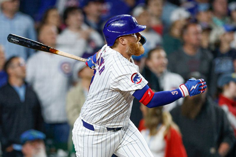 May 13, 2025; Chicago, Illinois, USA; Chicago Cubs first base Justin Turner (3) hits a walk-off two-run double against the Miami Marlins during the ninth inning at Wrigley Field. Mandatory Credit: Kamil Krzaczynski-Imagn Images