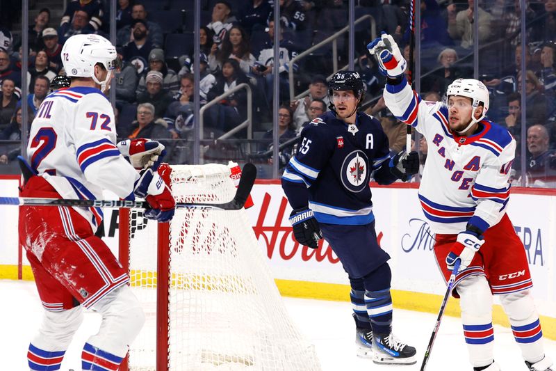 Oct 30, 2023; Winnipeg, Manitoba, CAN; New York Rangers left wing Artemi Panarin (10) celebrates his first period goal with center Filip Chytil (72) as Winnipeg Jets center Mark Scheifele (55) looks on in the first period at Canada Life Centre. Mandatory Credit: James Carey Lauder-USA TODAY Sports