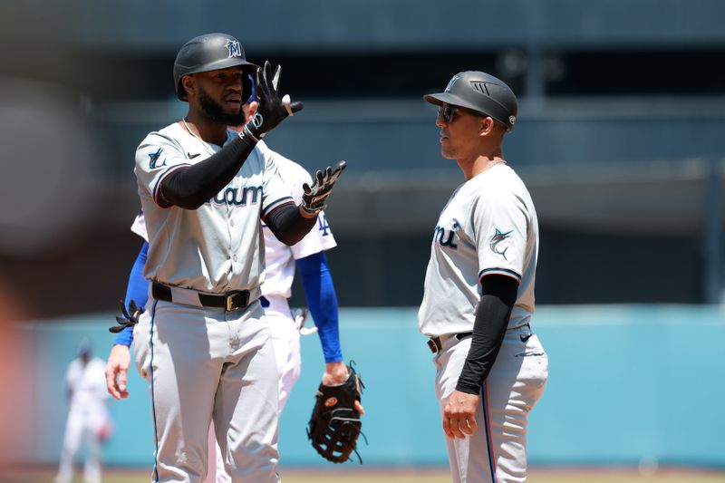 May 8, 2024; Los Angeles, California, USA;  Miami Marlins designated hitter Bryan De La Cruz (14) reacts after hitting a single during the sixth inning against the Los Angeles Dodgers at Dodger Stadium. Mandatory Credit: Kiyoshi Mio-USA TODAY Sports