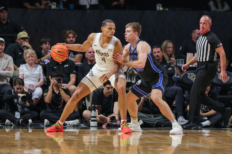 Feb 1, 2025; Orlando, Florida, USA; Brigham Young Cougars guard Dallin Hall (30) defends UCF Knights guard Keyshawn Hall (4) during the second half at Addition Financial Arena. Mandatory Credit: Mike Watters-Imagn Images