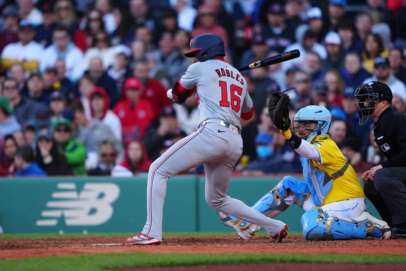 May 11, 2024; Boston, Massachusetts, USA; Washington Nationals right fielder Victor Robles (16) gets hit by a pitch against the Boston Red Sox during the eighth inning at Fenway Park. Mandatory Credit: Gregory Fisher-USA TODAY Sports