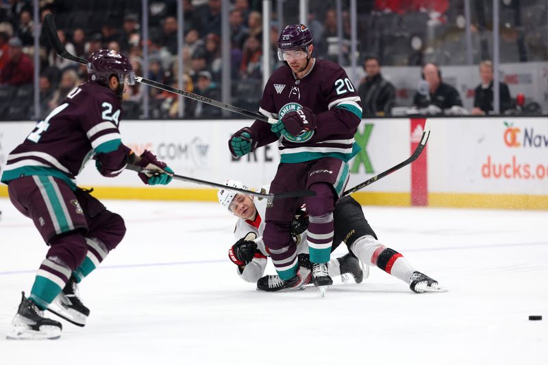 Mar 6, 2024; Anaheim, California, USA;  Ottawa Senators center Tim Stutzle (18) passes the puck around Anaheim Ducks right wing Brett Leason (20) during the first period at Honda Center. Mandatory Credit: Kiyoshi Mio-USA TODAY Sports