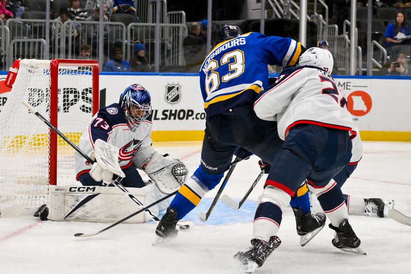 Oct 1, 2024; St. Louis, Missouri, USA;  Columbus Blue Jackets goaltender Jet Greaves (73) defends the net against St. Louis Blues left wing Jake Neighbours (63) during the second period at Enterprise Center. Mandatory Credit: Jeff Curry-Imagn Images