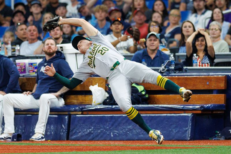 May 28, 2024; St. Petersburg, Florida, USA;  Oakland Athletics second baseman Zack Gelof (20) makes a diving catch in foul territory against the Tampa Bay Rays in the first inning at Tropicana Field. Mandatory Credit: Nathan Ray Seebeck-USA TODAY Sports