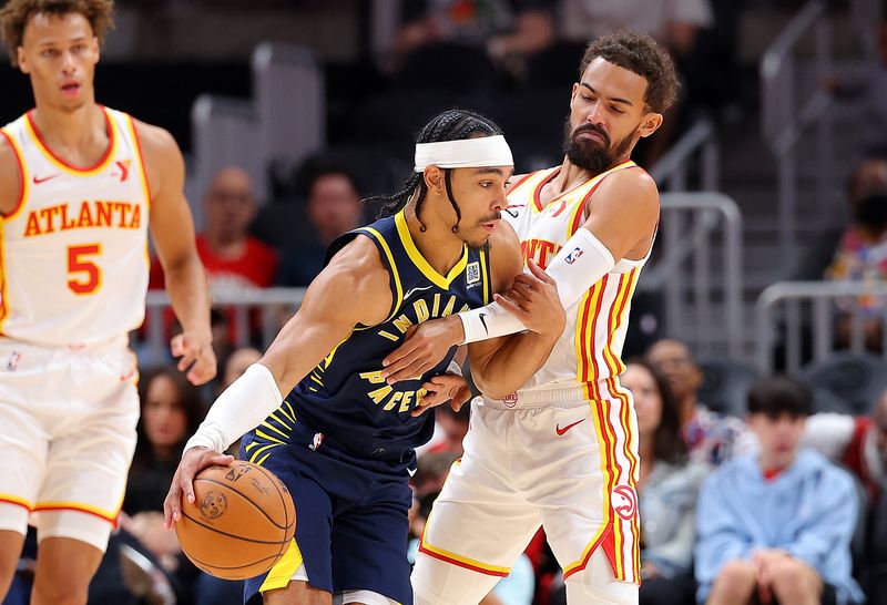 ATLANTA, GEORGIA - OCTOBER 08:  Andrew Nembhard #2 of the Indiana Pacers drives against Trae Young #11 of the Atlanta Hawks during the first quarter at State Farm Arena on October 08, 2024 in Atlanta, Georgia.  NOTE TO USER: User expressly acknowledges and agrees that, by downloading and/or using this photograph, user is consenting to the terms and conditions of the Getty Images License Agreement.  (Photo by Kevin C. Cox/Getty Images)